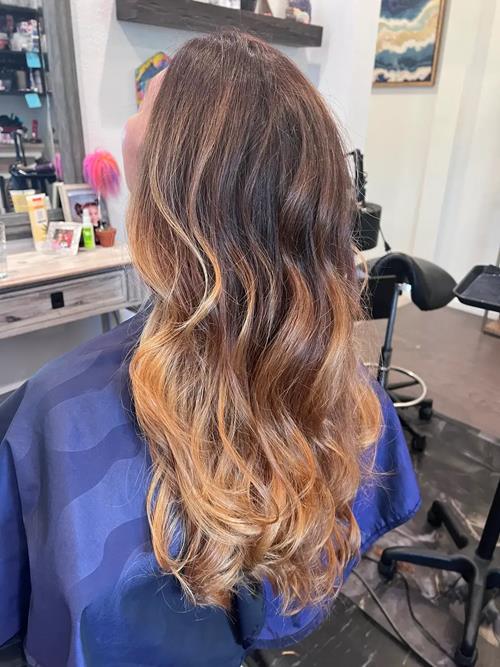 Denver Hair Extensions A soft side angle showing warm caramel and honey tones blended for natural mo(..)